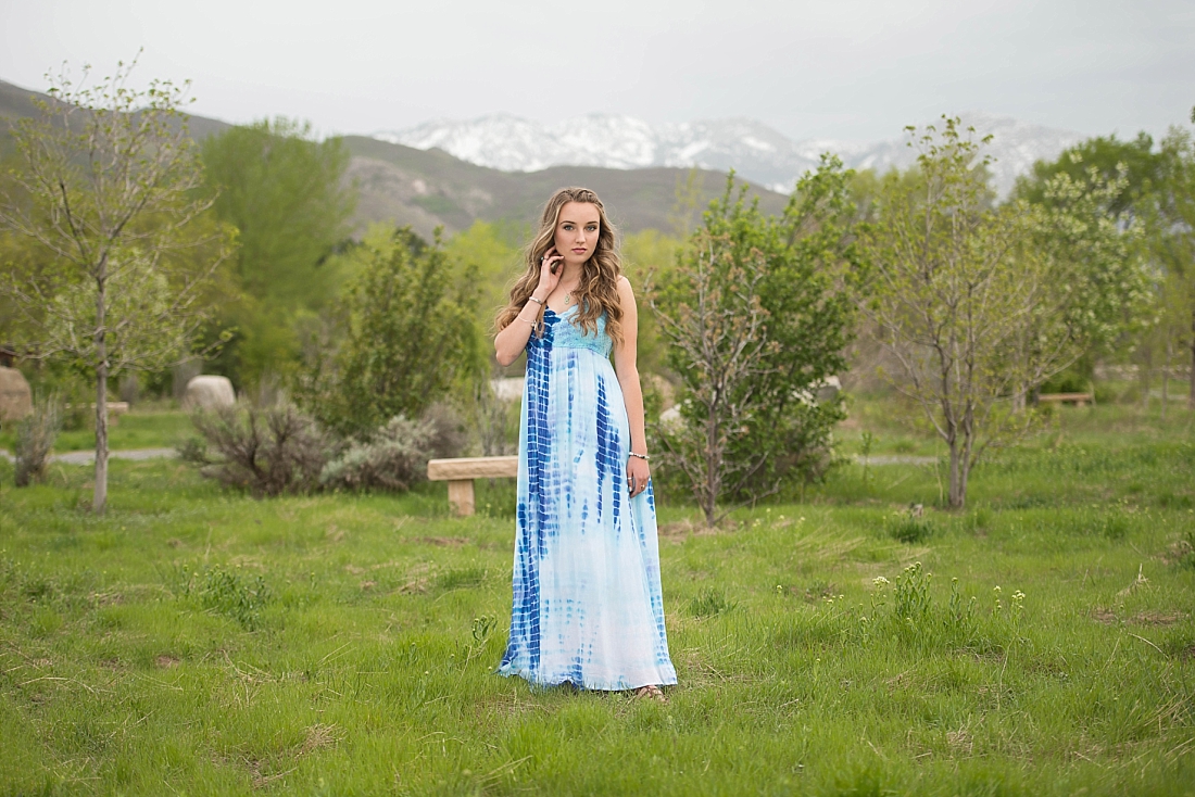 girl in blue tie dye dress with mountains in the background