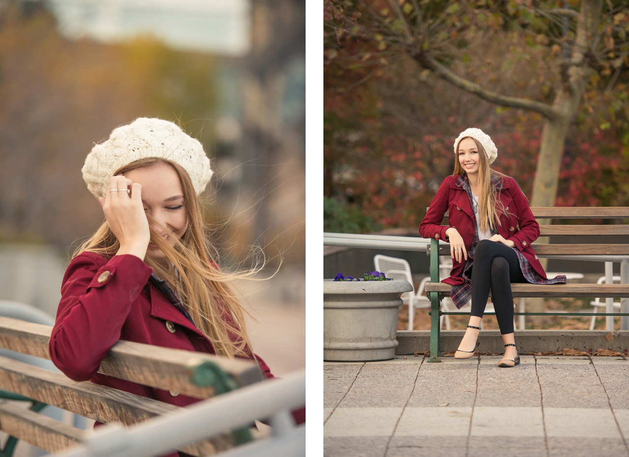 Girl wearing a red pea coat and a knit hat sitting on a park bench