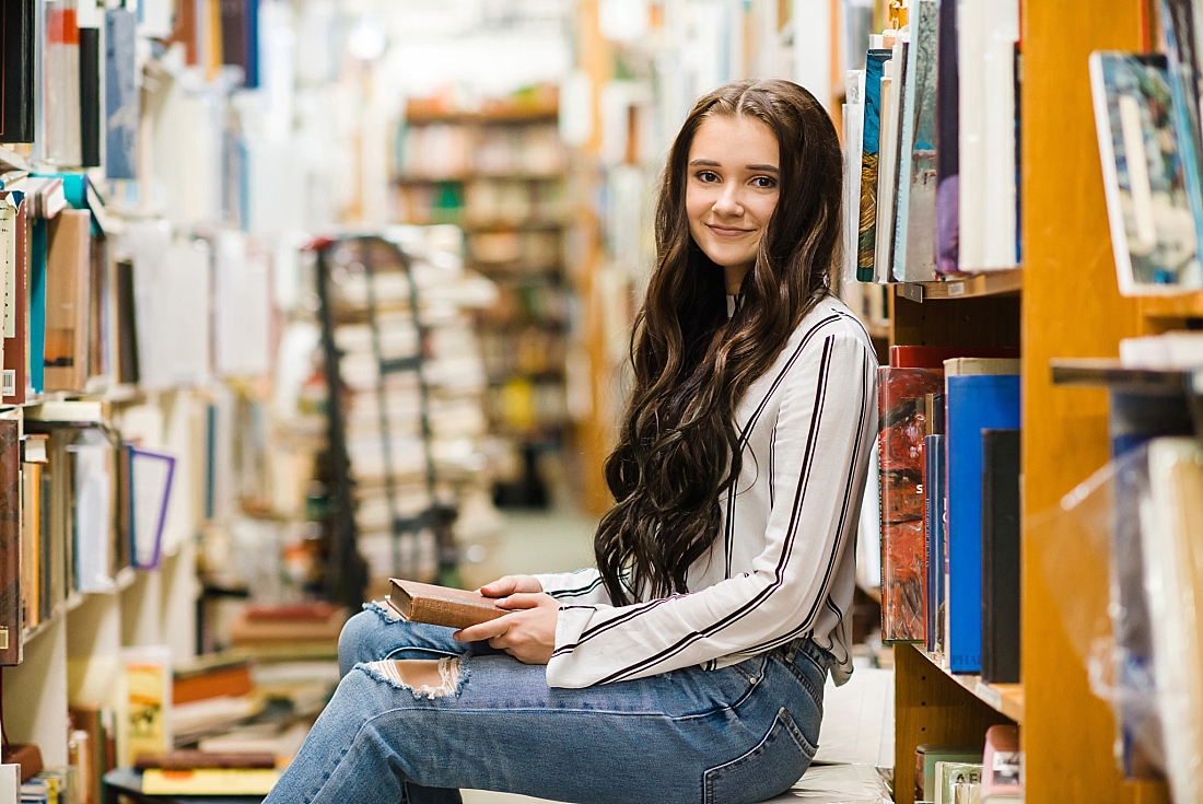 Girl sitting in bookstore with a book