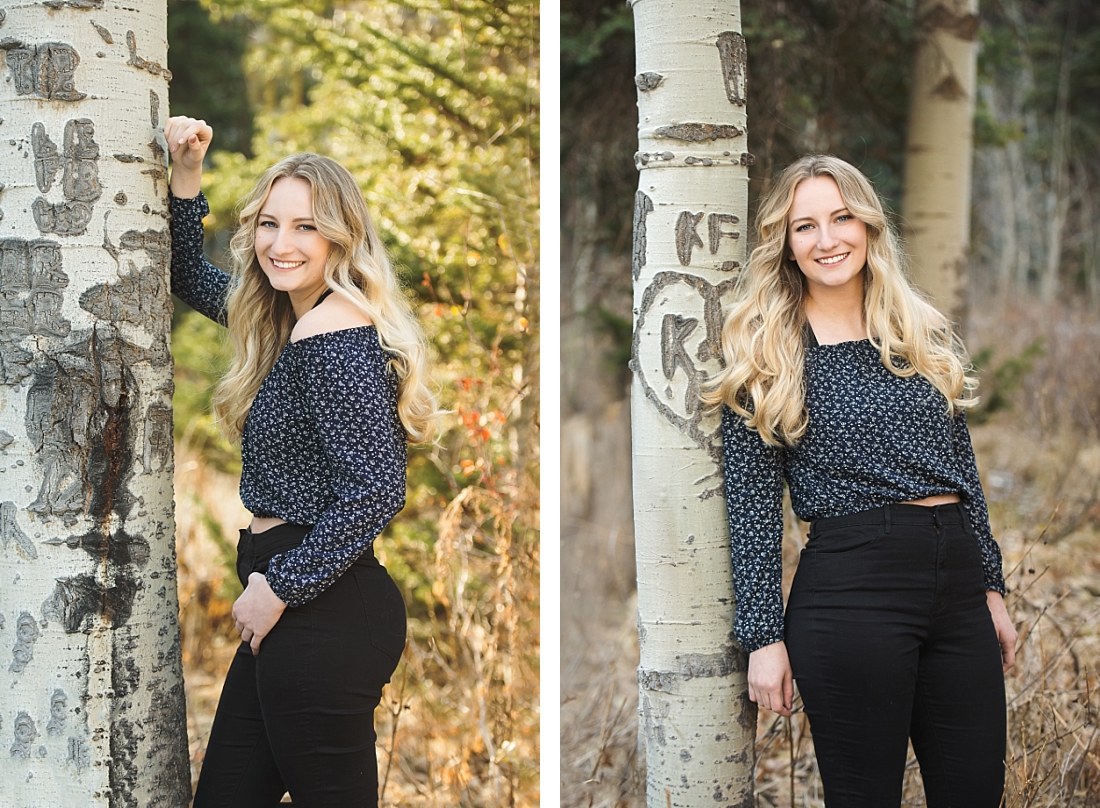 Utah senior portraits in the fall standing by an aspen tree