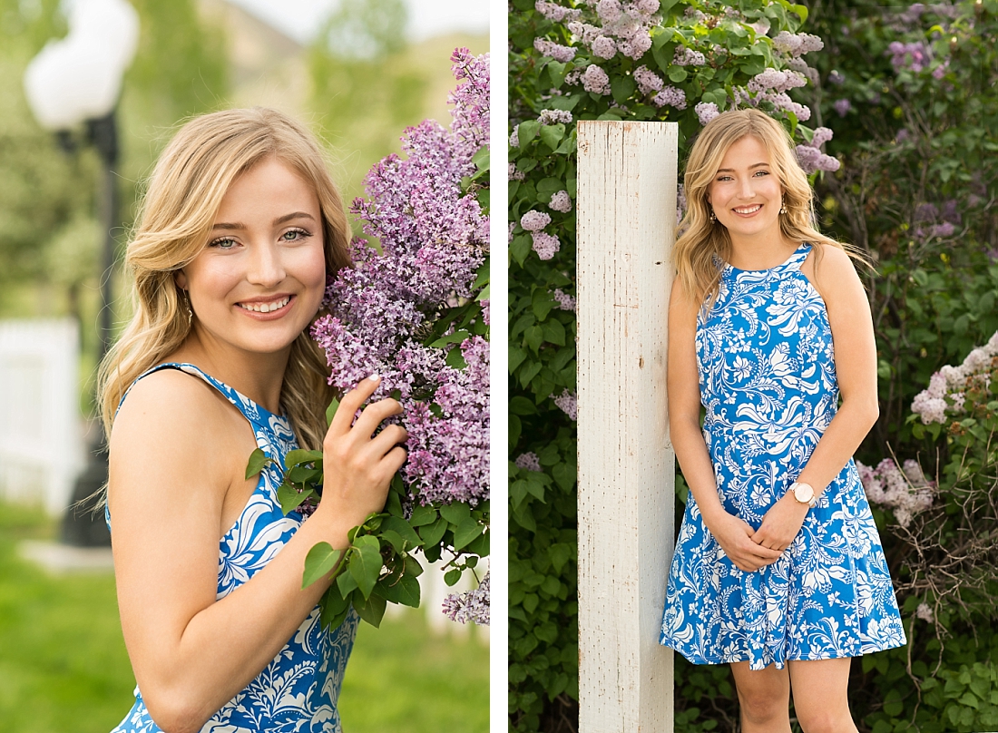 Skyline High Senior girl in blue floral dress standing by purple lilacs