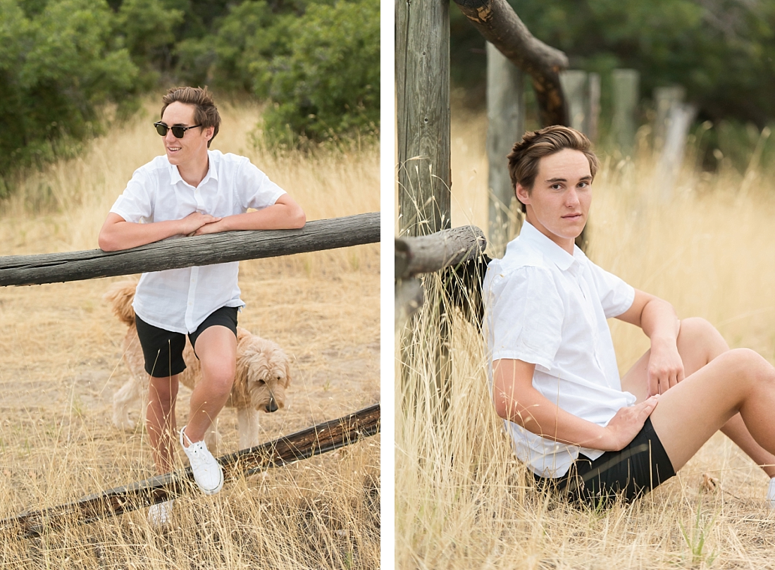 utah senior portrait boy in white shirt and black shorts sitting against a fence in dimple dell
