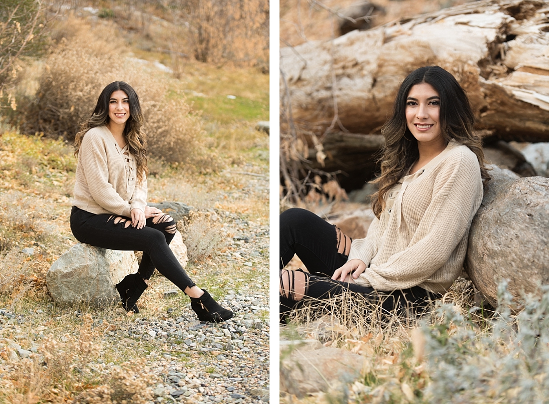 Wyoming senior pictures girl in black pants with holes and a tan sweater sitting in the fall leaves