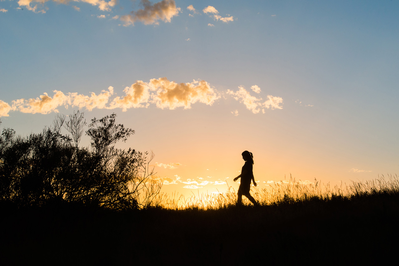 utah senior portrait silhouette of girl walking at sunset