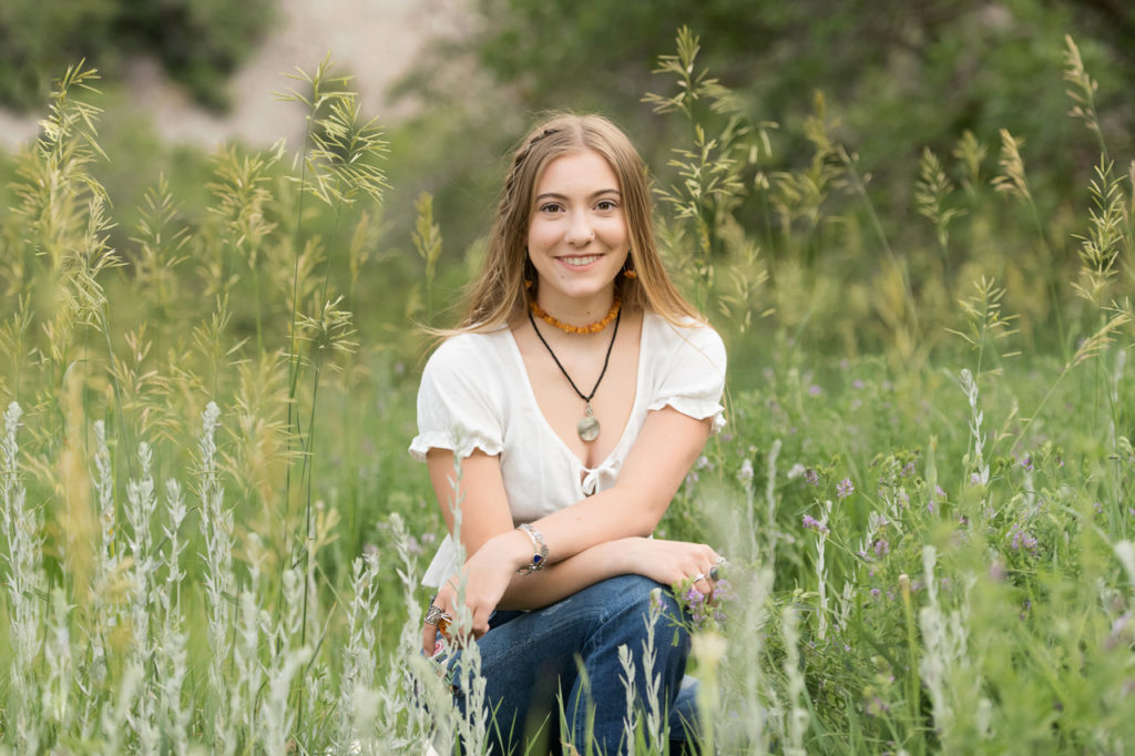 Utah Senior Pictures girl in white shirt in grassy field