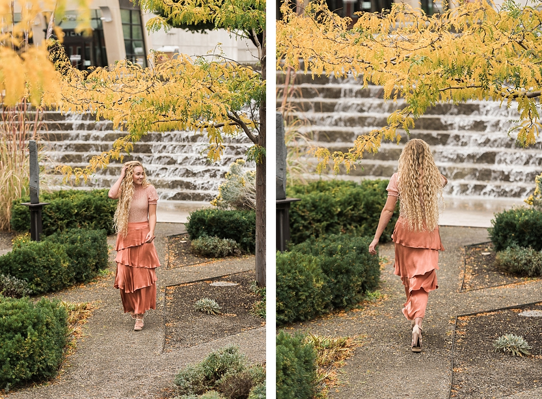Girl walking through garden with waterfall