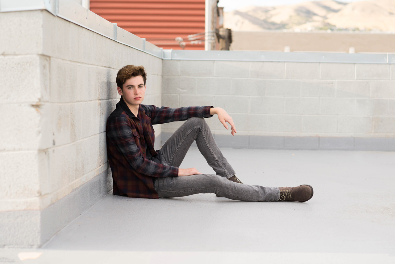 boy sitting on a rooftop
