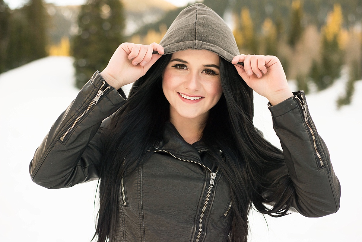 Utah Senior Portraits in the snow with a girl in a black leather jacket in the winter