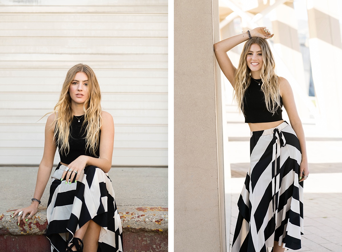 Girl with black and white striped skirt in a grungy urban setting for senior portraits