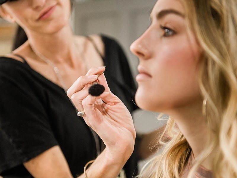 Makeup Artist applying powder with a makeup brush
