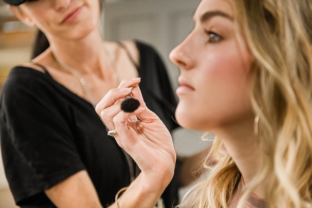 Makeup Artist applying powder with a makeup brush