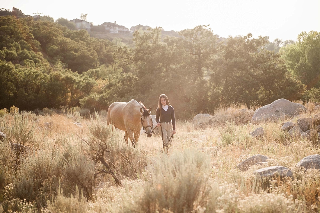 Girl and horse walking through dimple dell